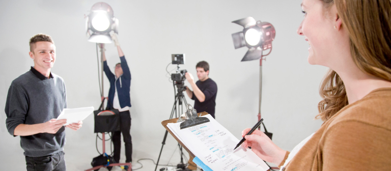 Dramatic writing student reviewing script on set Dramatic writing student reviewing script on set