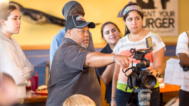 Film and television professor instructing students on set Film and television professor instructing students on set
