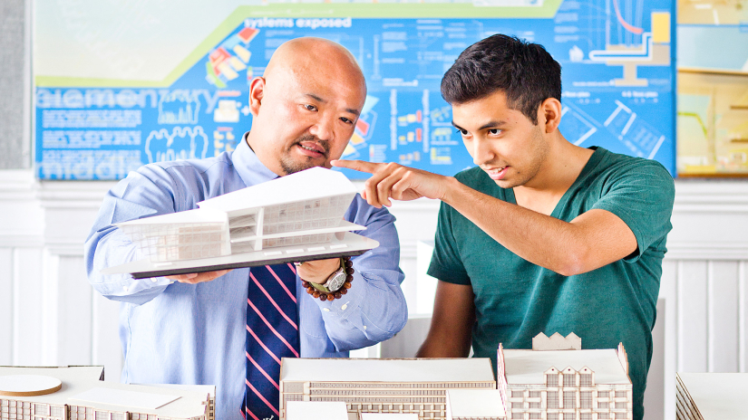 Architecture professor examining model with student Architecture professor examining model with student