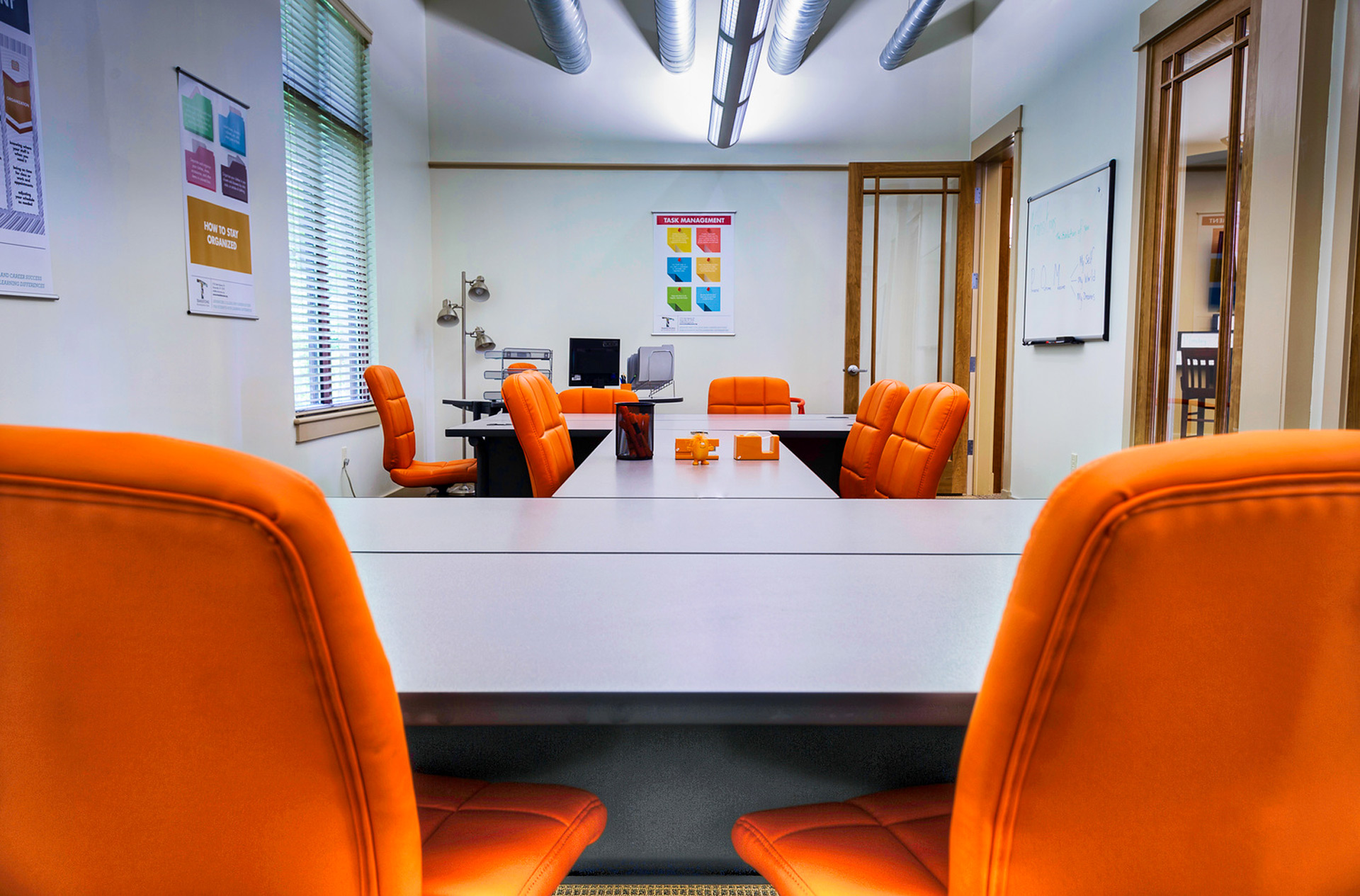 Conference room with bright orange office chairs