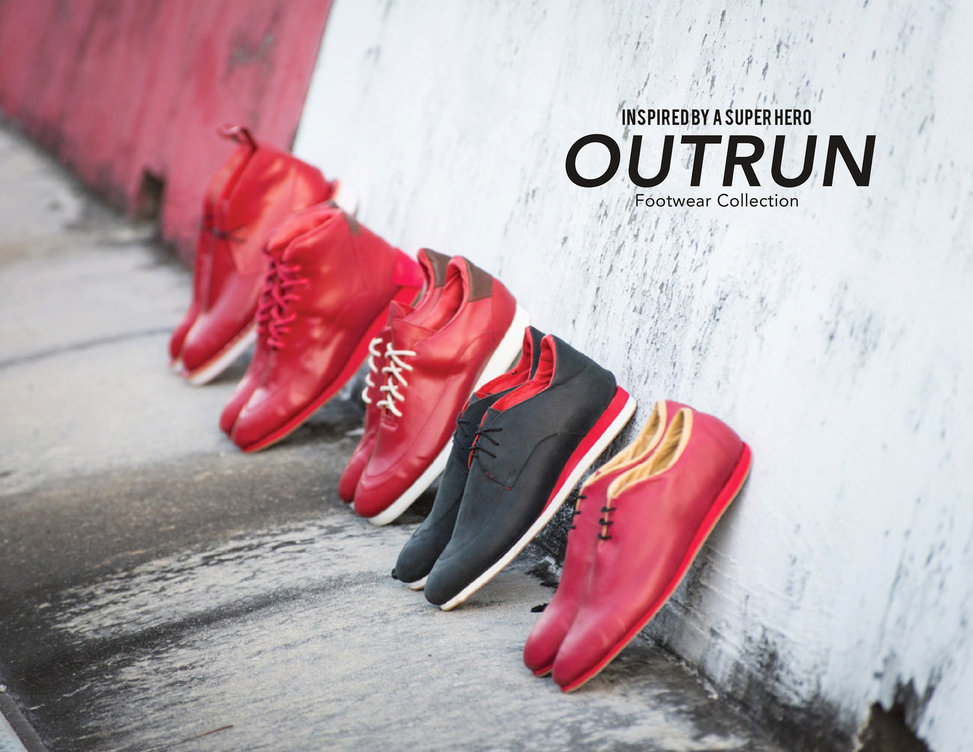 Four pairs of red shoes and one pair of black shoes with red accents lined up against wall