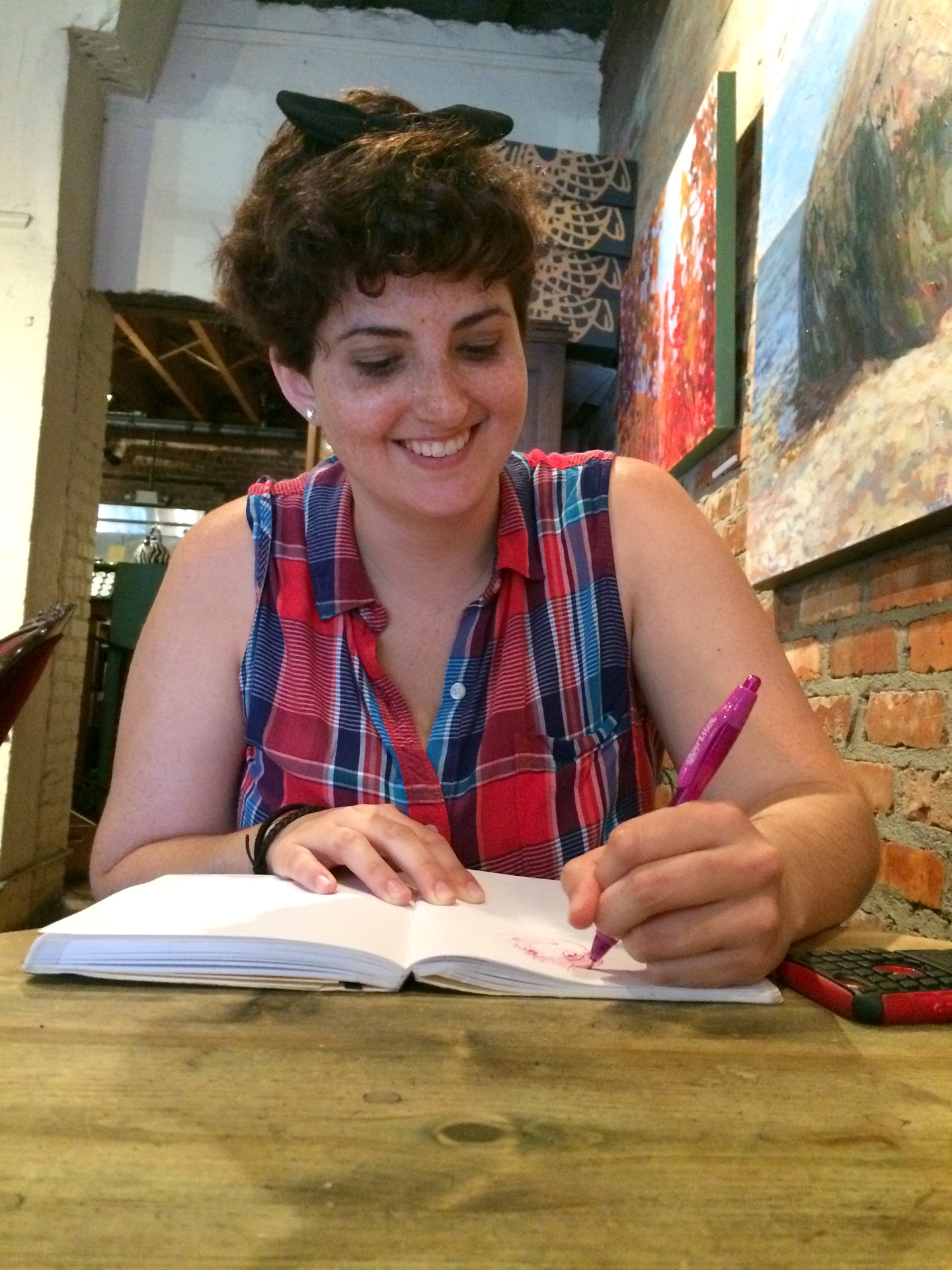 SCAD student works in a sketchbook