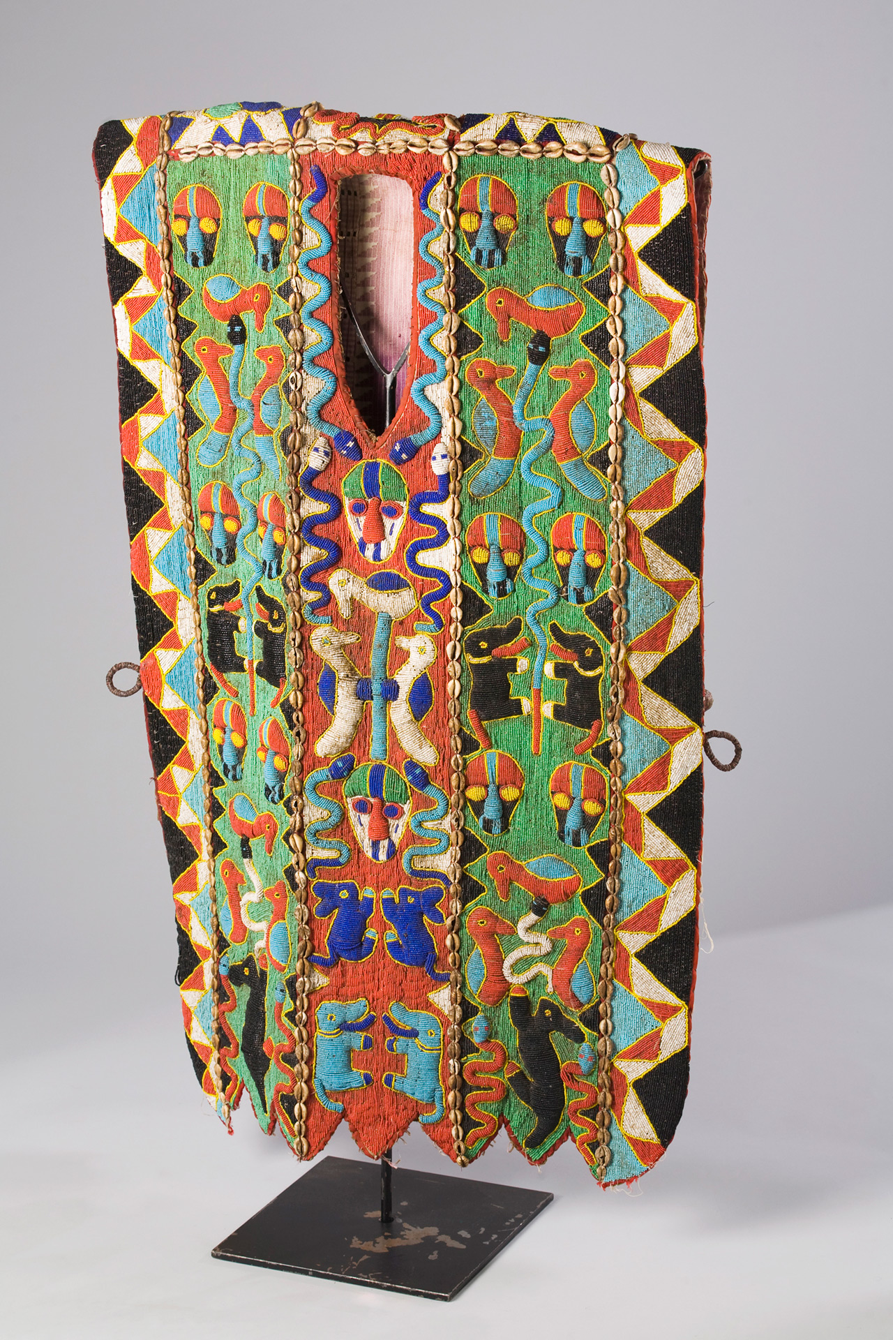 Colorfully embroidered fabric in greens and reds 