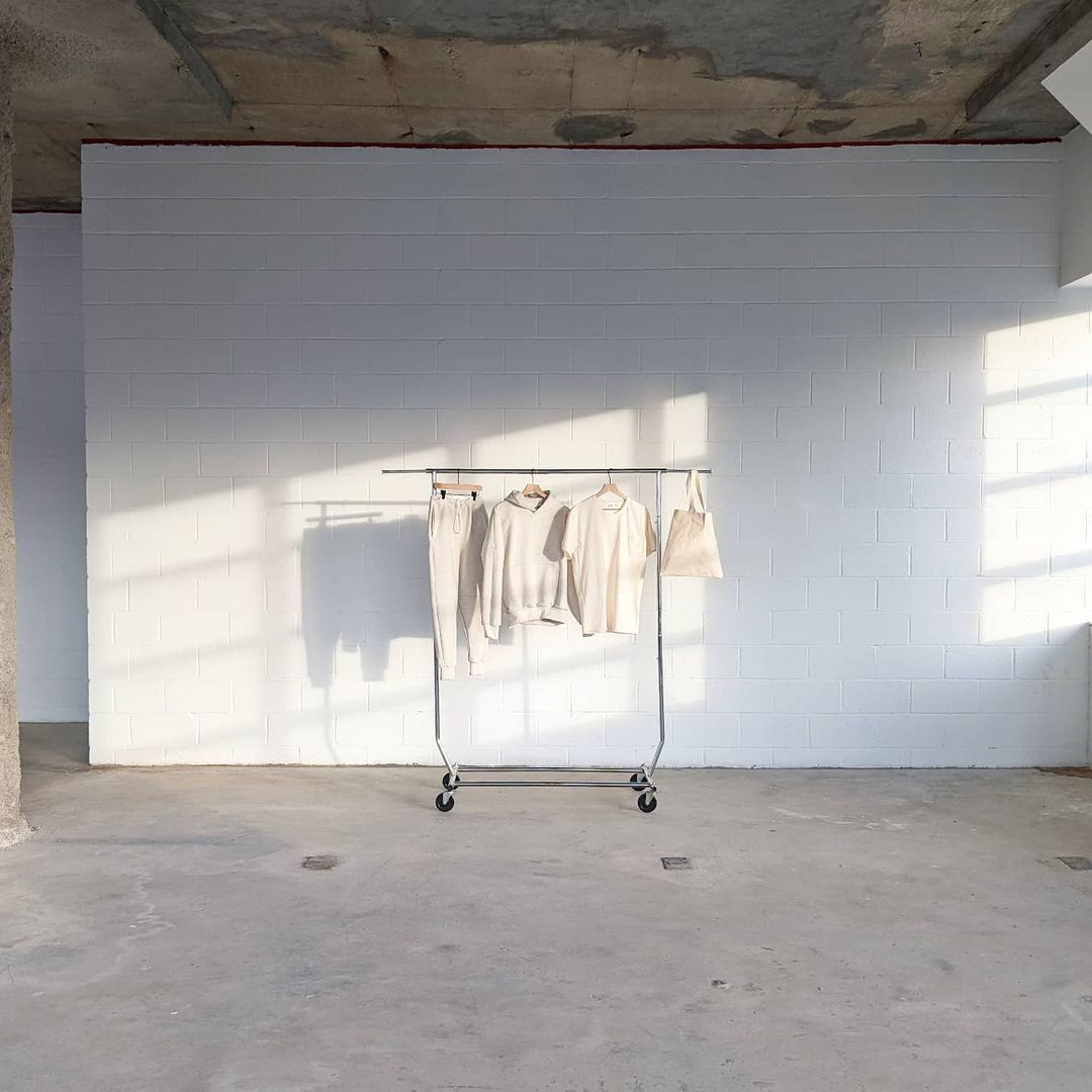 room with clothes on wardrobe rack