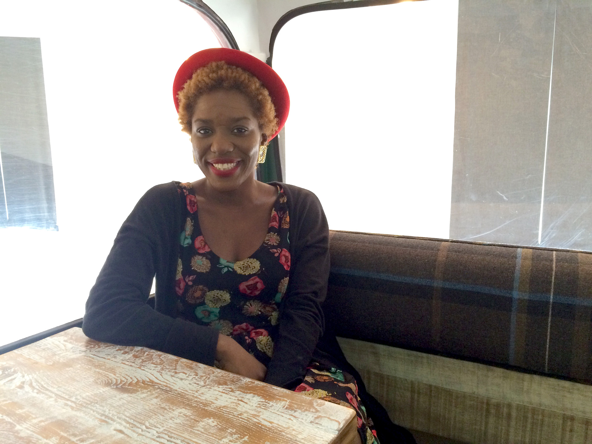 Alumna Merline Labissiere inside double decker bus at Art's Cafe in Savannah