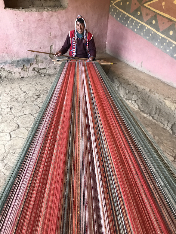 peruvian weaver working on loom