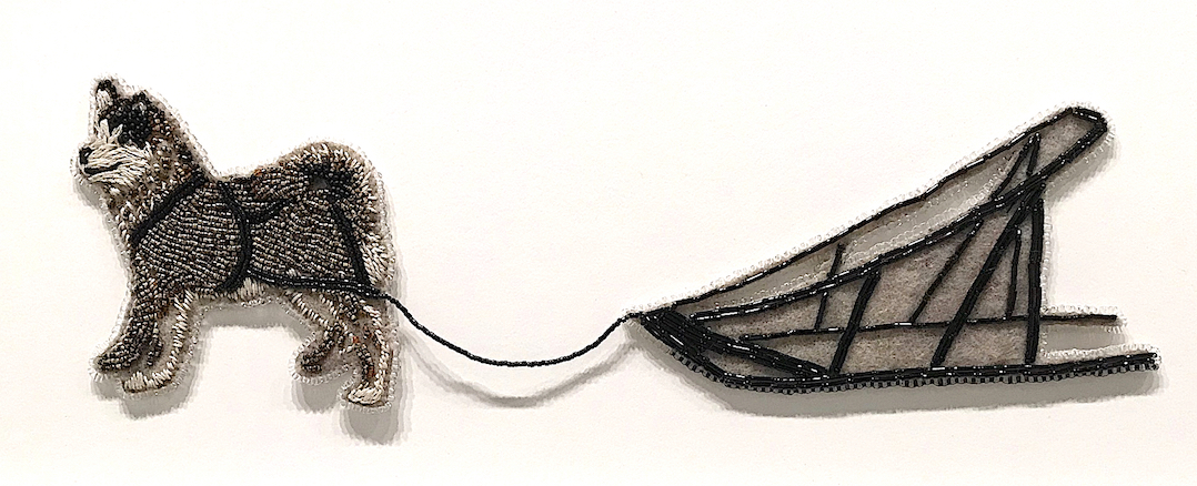 an embroidered sled dog and sled