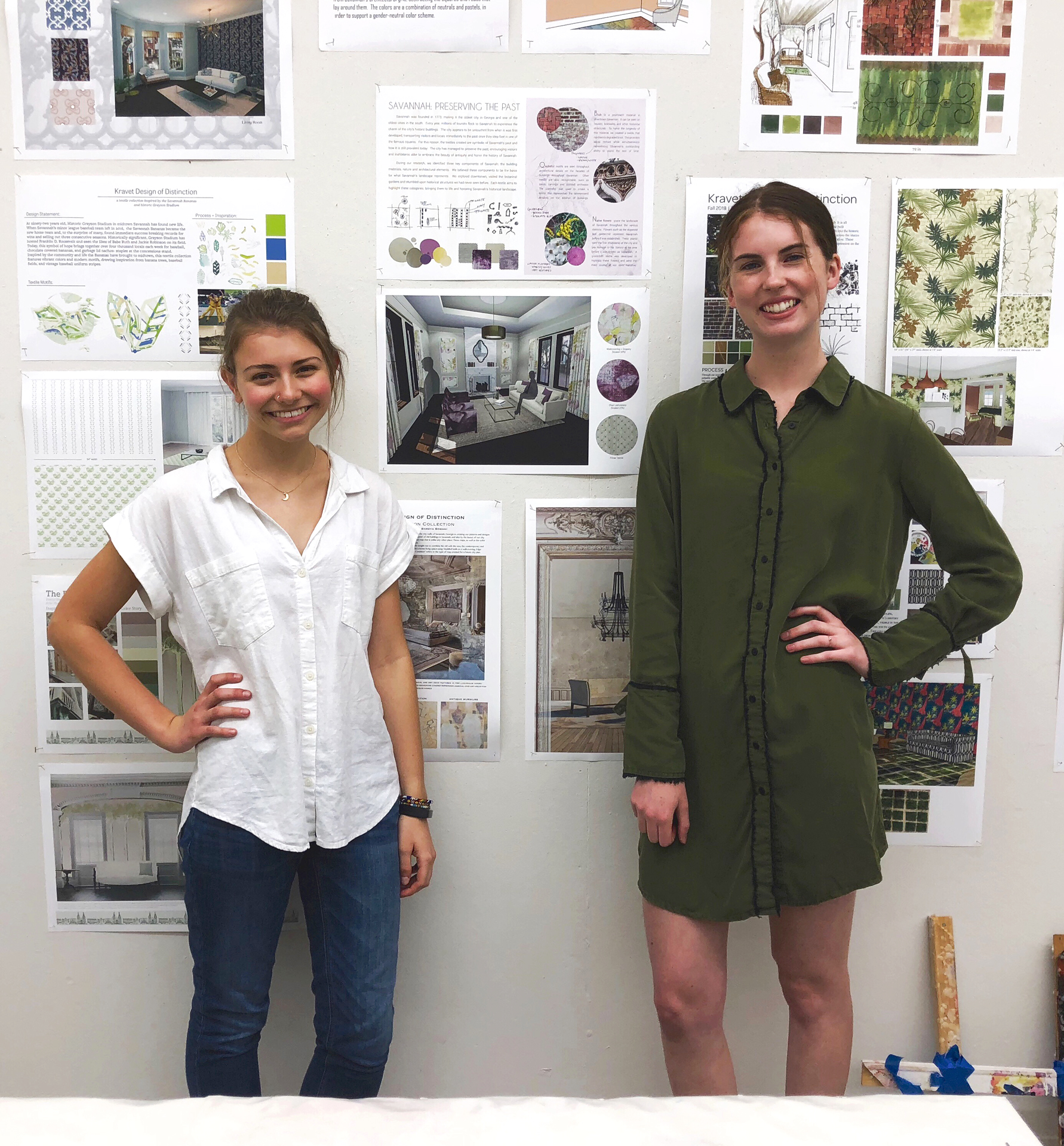 Pogue and Markham smile in front of print-outs of their design