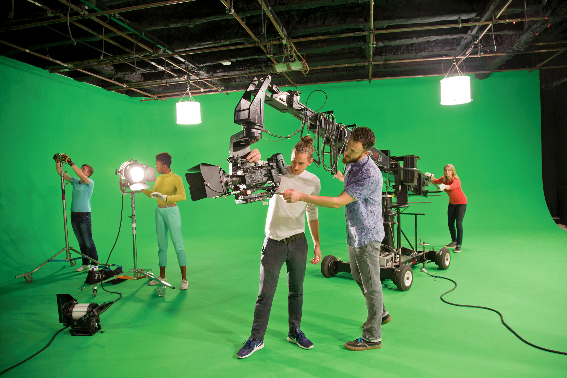Student film crew in front of green screen
