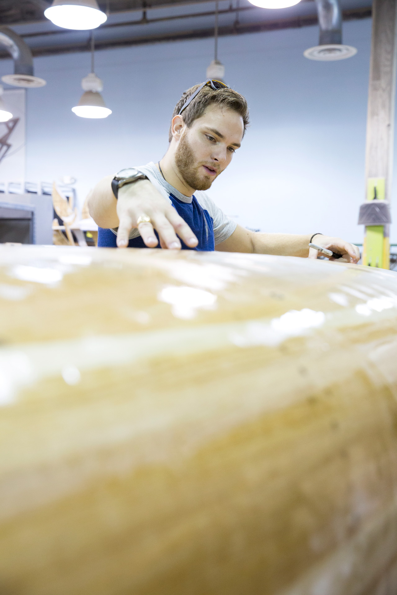 Paul Hawkins works over a wooden canoe