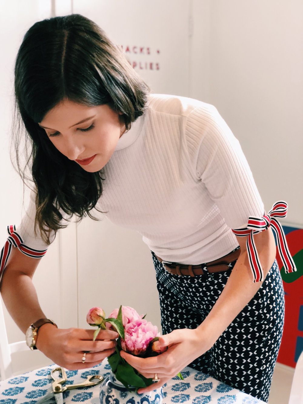 Daniel arranges pink flowers