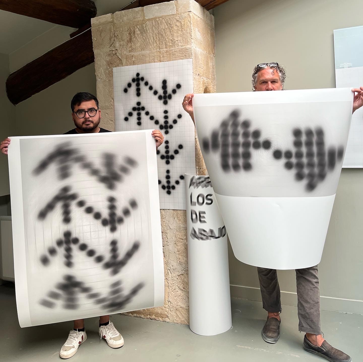 Gonzalo Hernandez and Todd Schroeder holding up prints