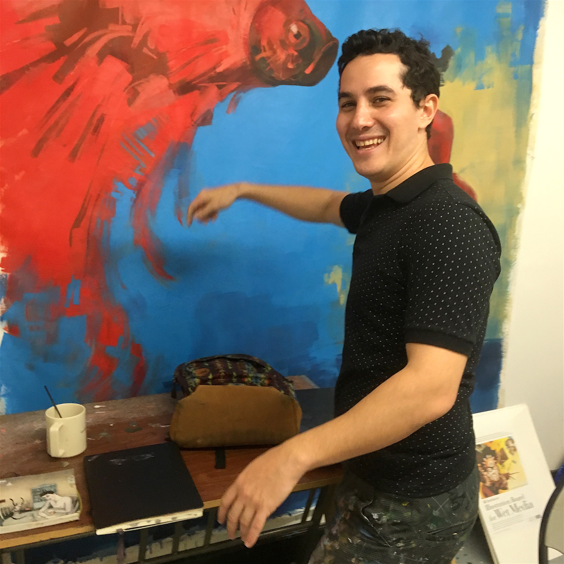 Covo works on large canvas with red fish set against a blue background