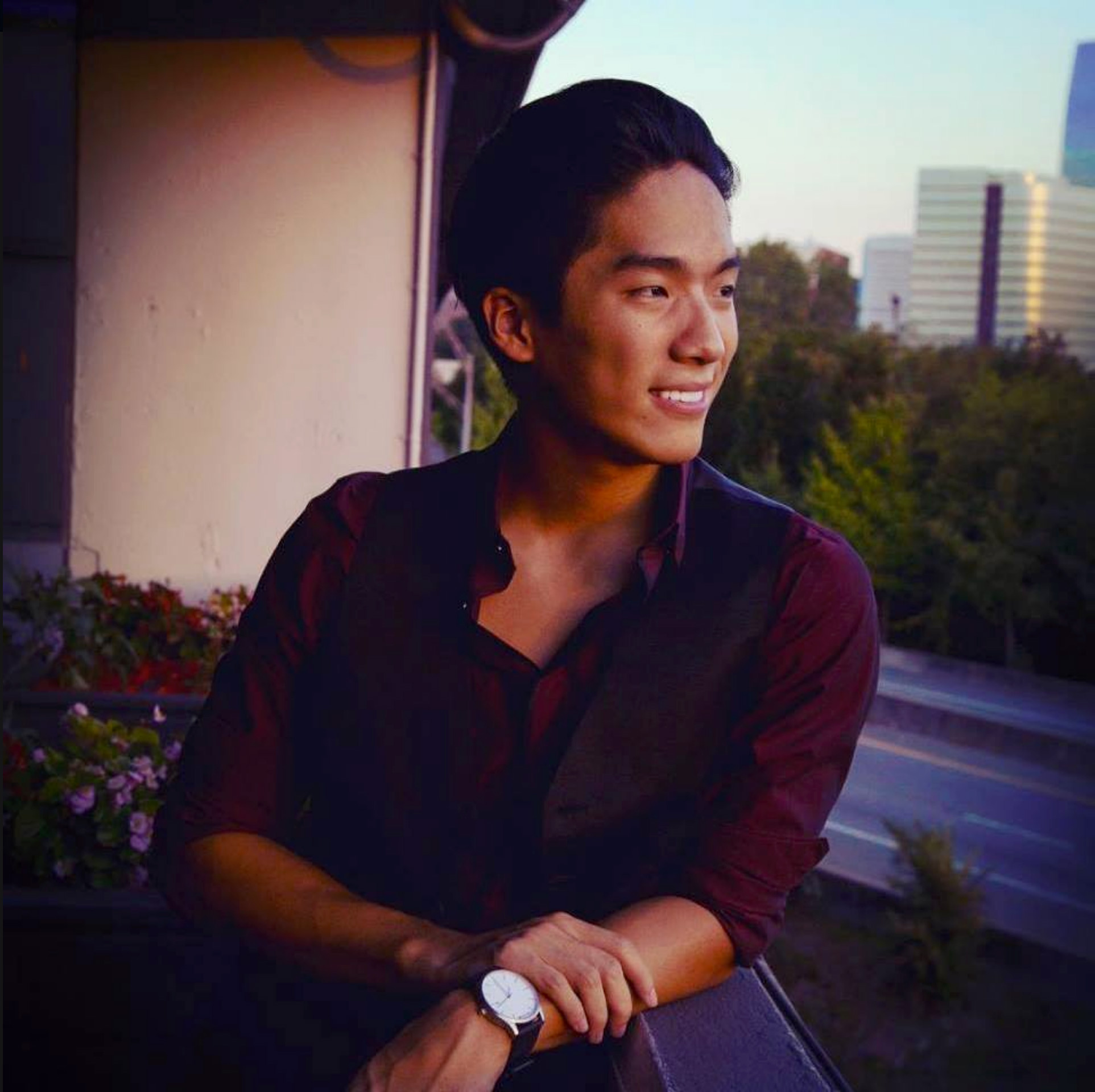 Ethan Ho in relaxed position looks off into the distance