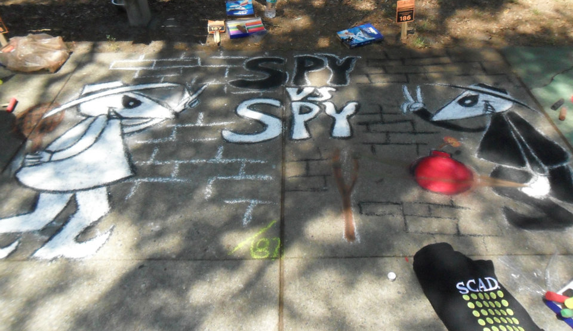 Detail of Spy vs. Spy sidewalk chalk artwork