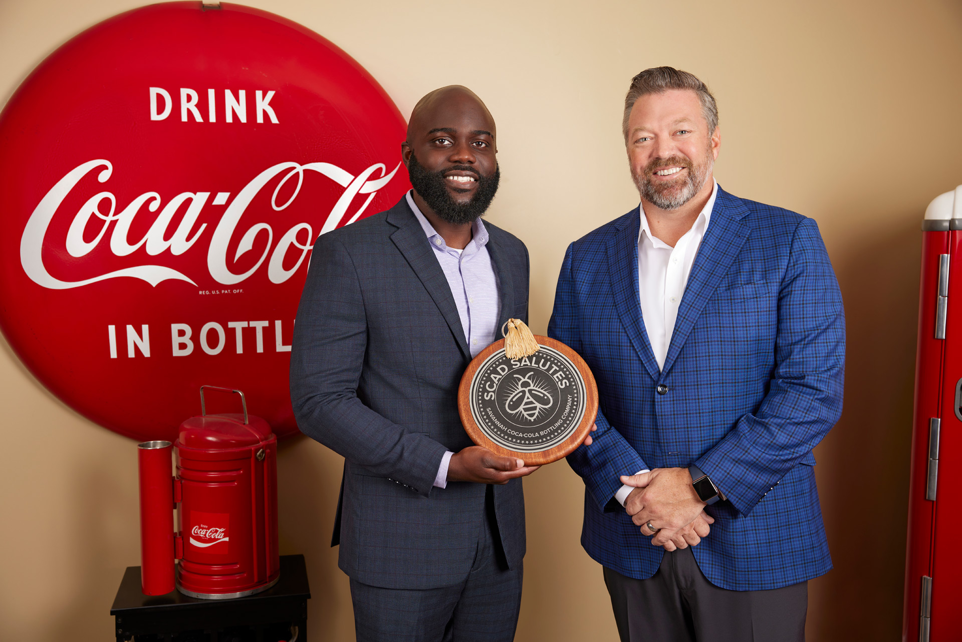 Savannah Coca-Cola Bottling Company sales center manager Eric Nyantakyi and director Jack Sherman receive the SCAD Salutes award 
