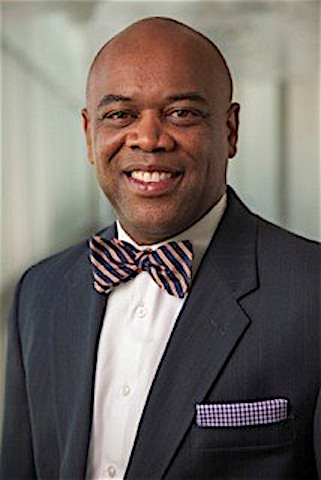 Darrell Naylor Johnson smiles in suit with bowtie