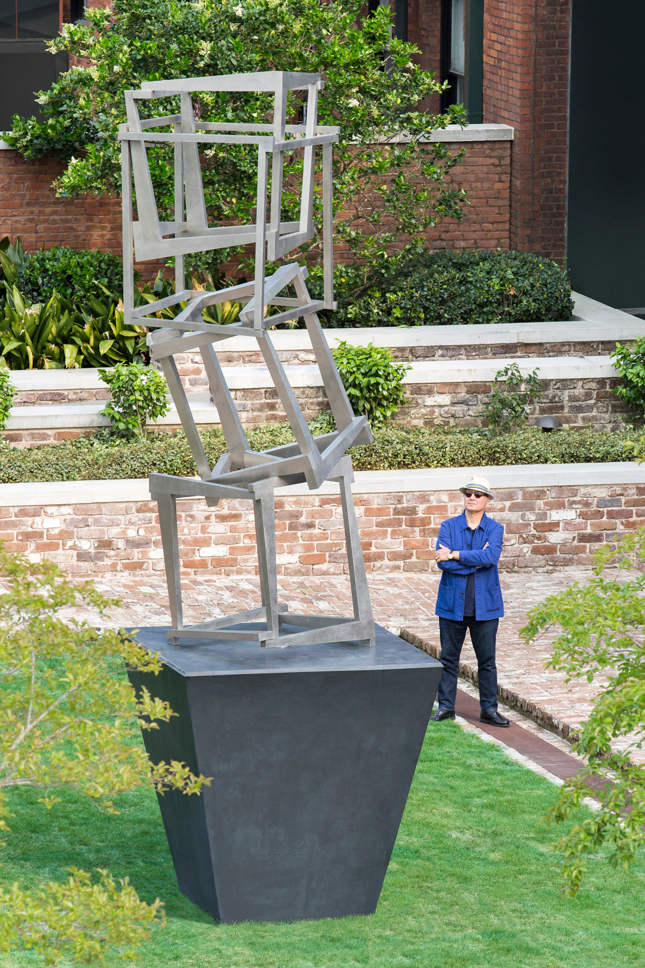 The artist looks at his work in the Museum's courtyard