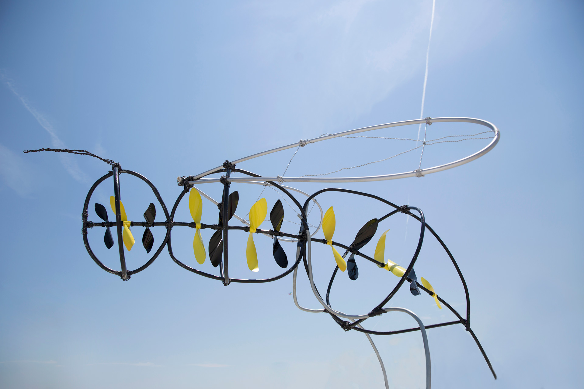 Bee wind sculpture made up with black and white propellers