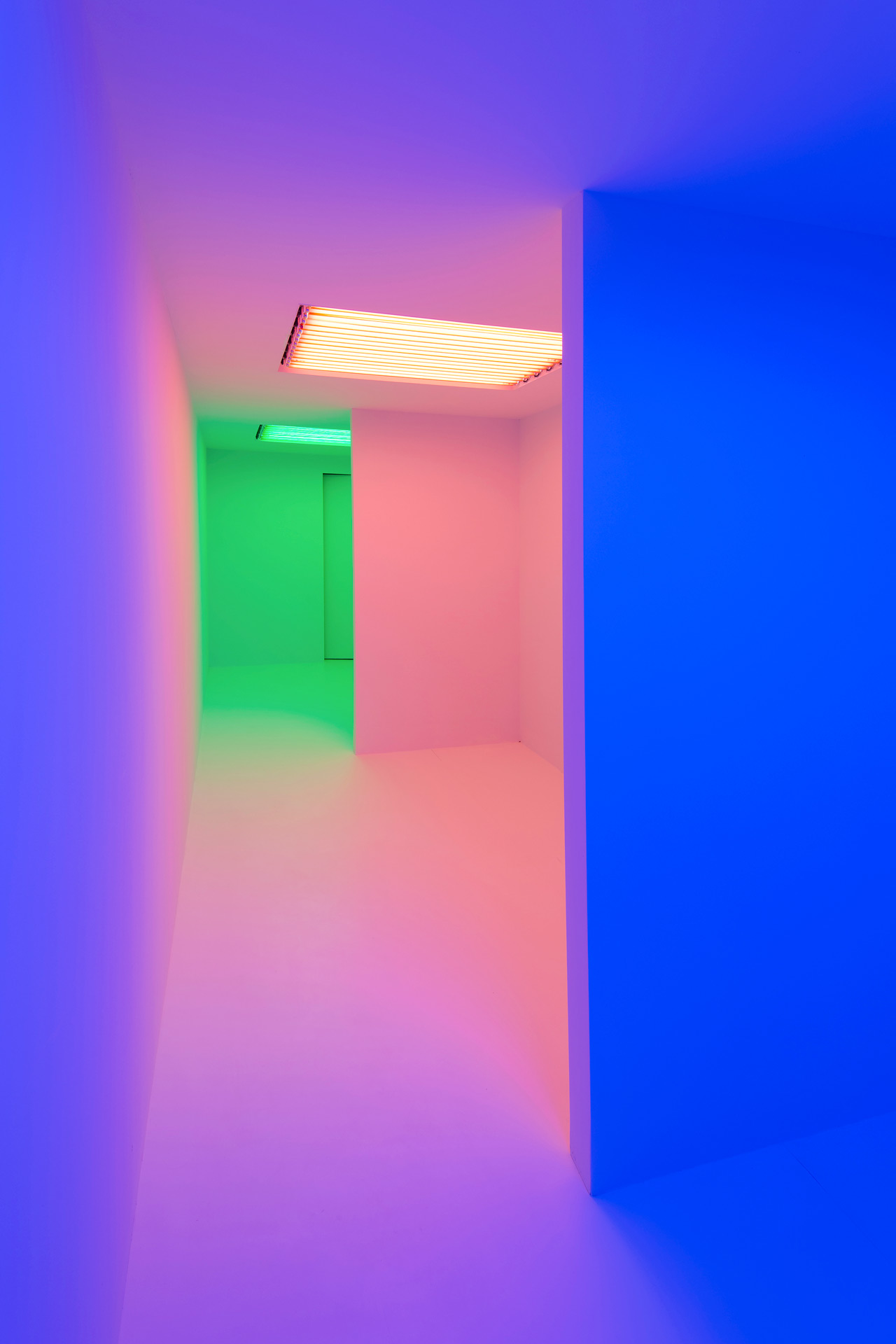 Series of three rooms each bathed in different colors starting with blue, pink then green
