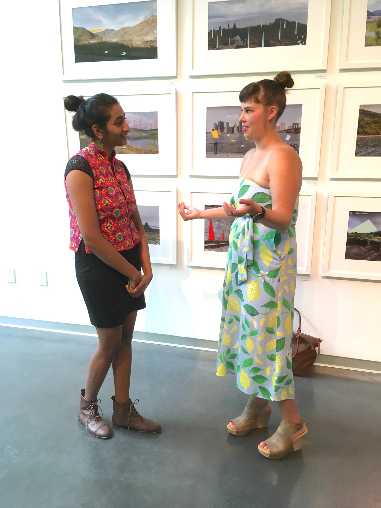 Artist discusses her work in gallery with museum goer