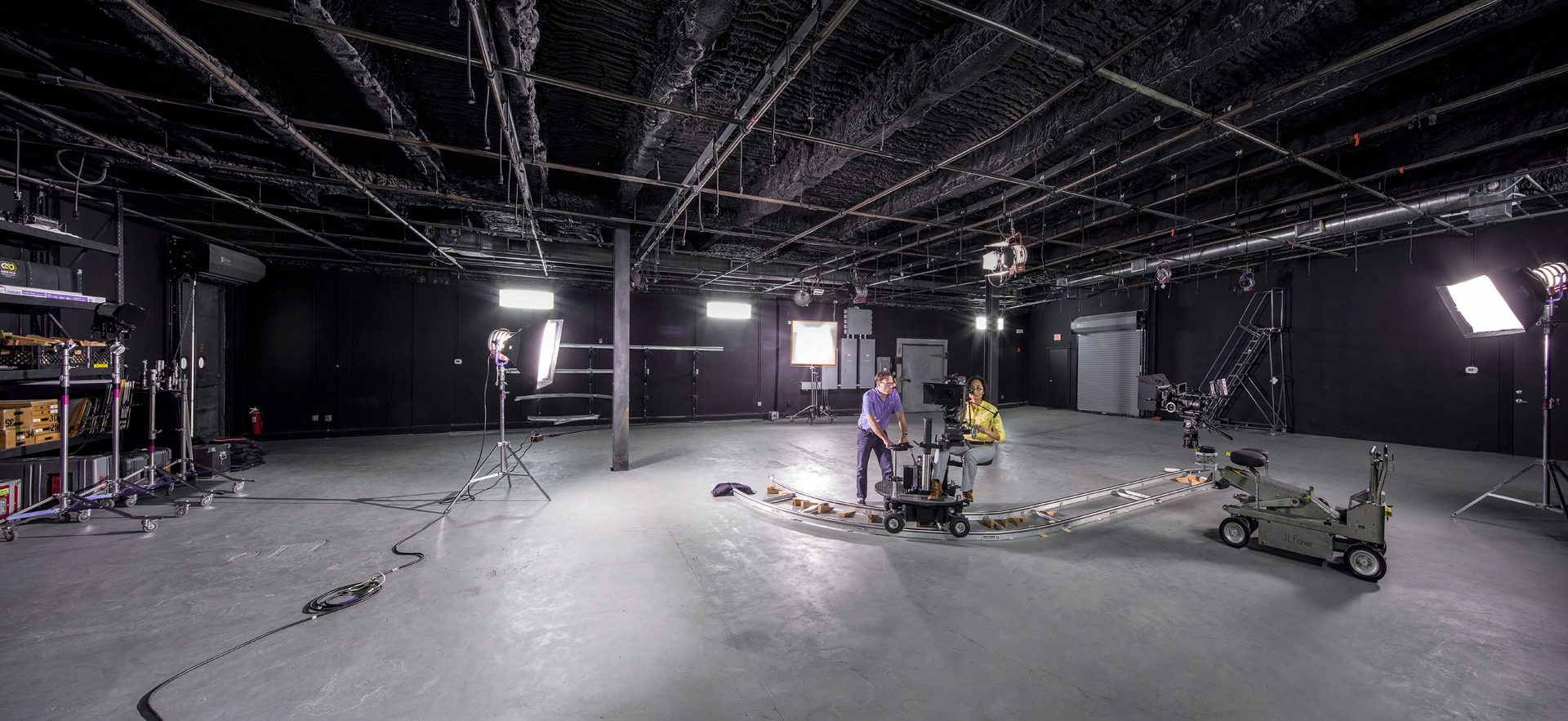 Student film crew on empty stage