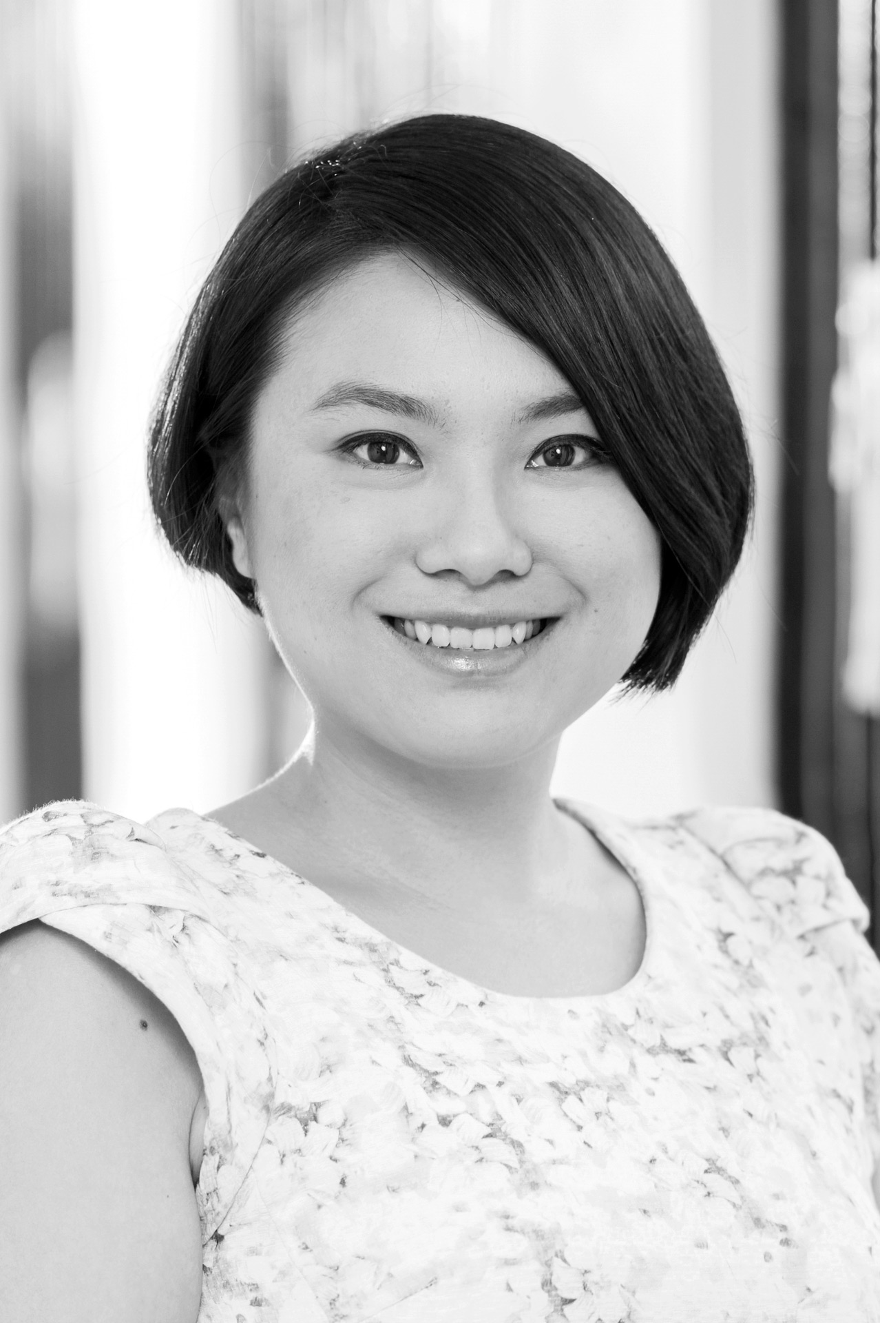 Artist Kayo Chang smiles in this black and white portrait