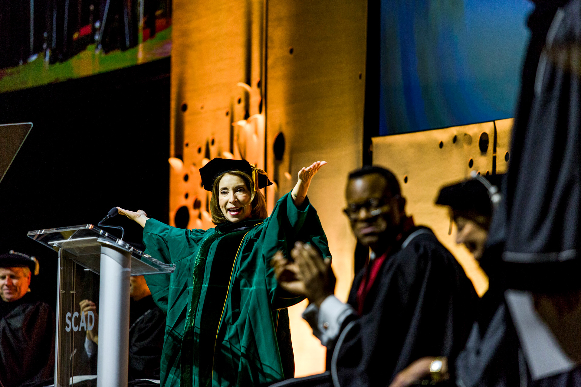 President Paula Wallace raises her hands in celebration