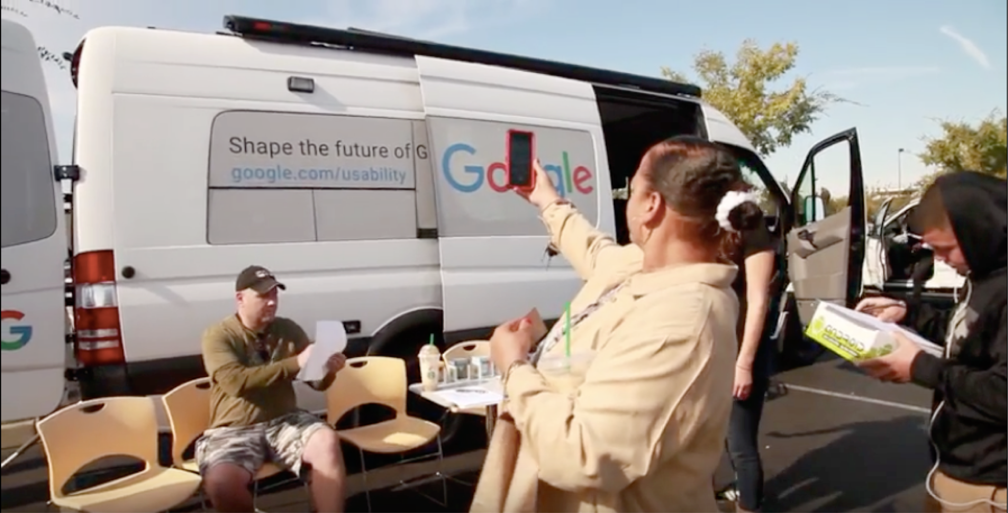 Woman takes photograph of Google Usability Van
