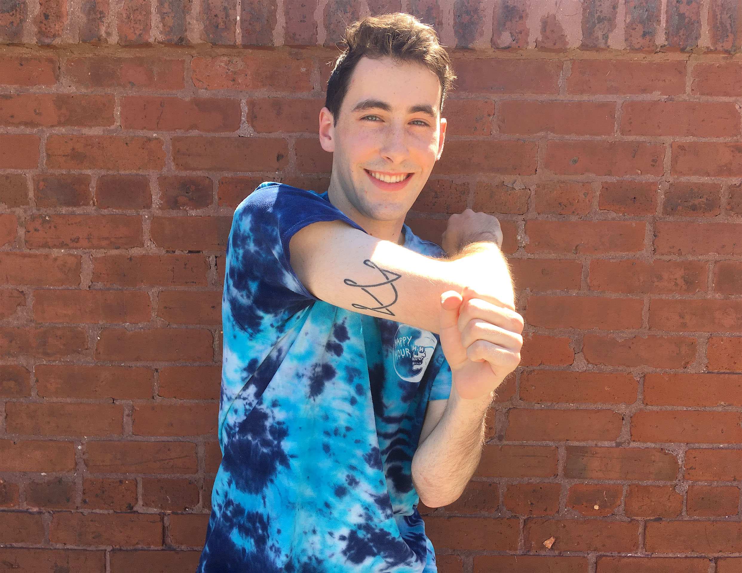 Student Gabe Crown shows off tattoo on the back of his arm