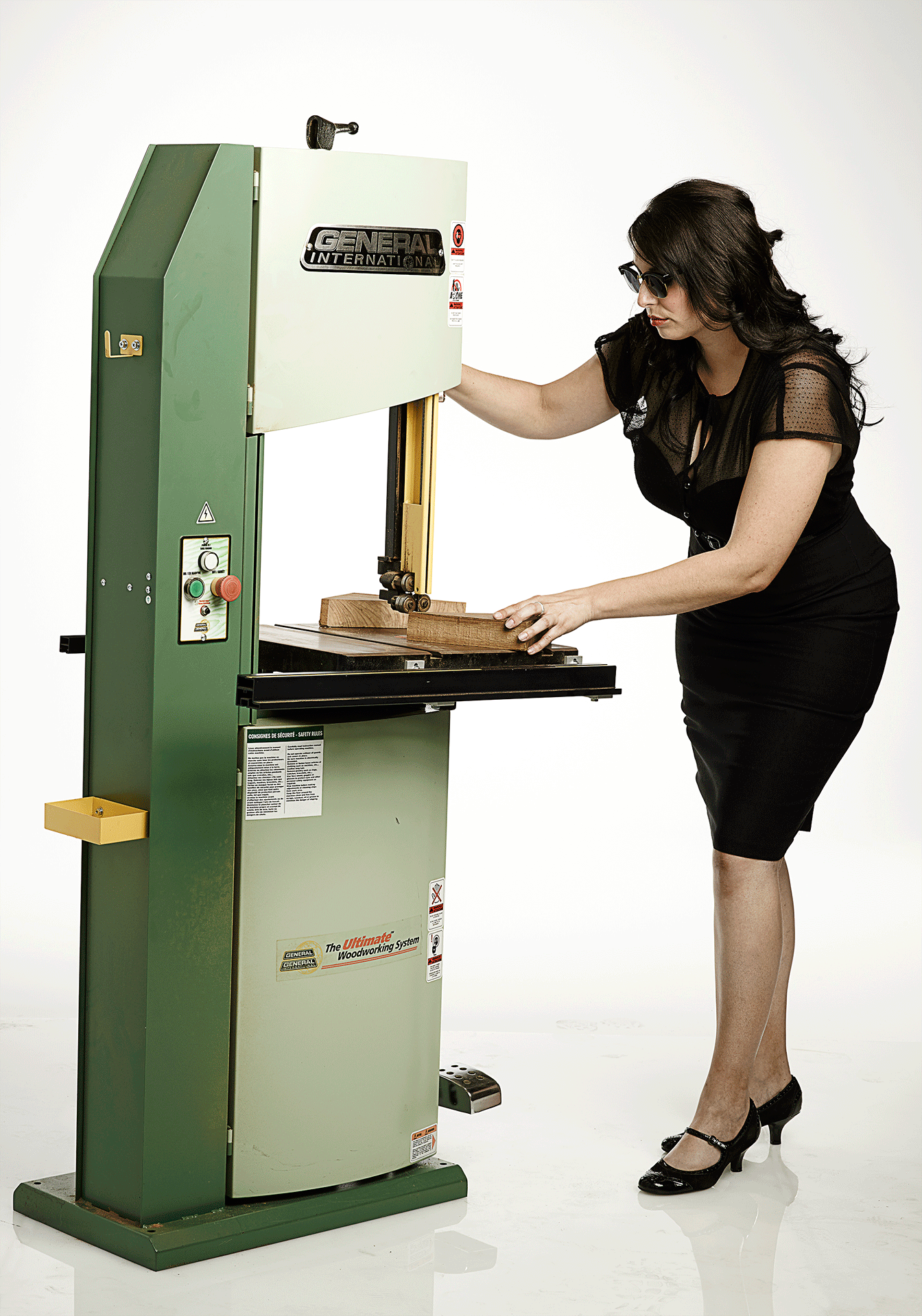 Furniture design student Lacey Campbell cuts wood on large machine