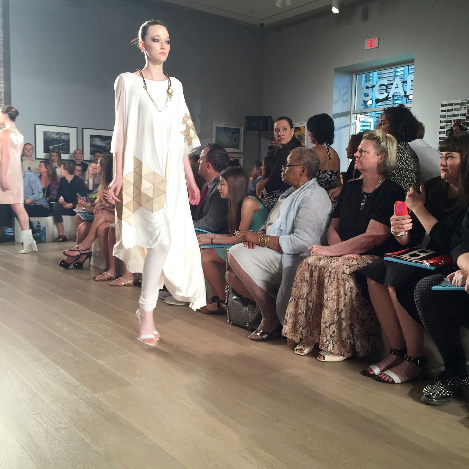 Model wearing Molly Sayers garment walks down SCAD runway