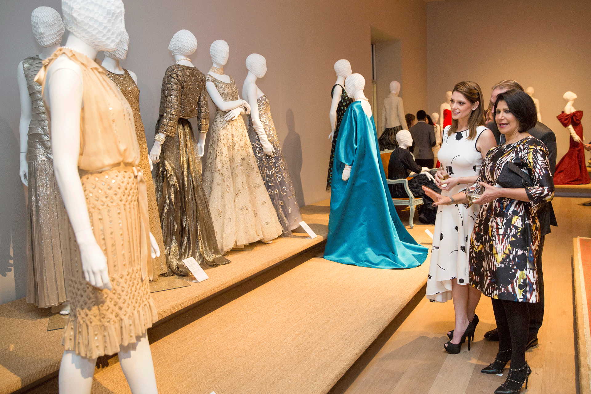 Visitors preview Oscar de la Renta dresses on display at SCAD Museum of Art