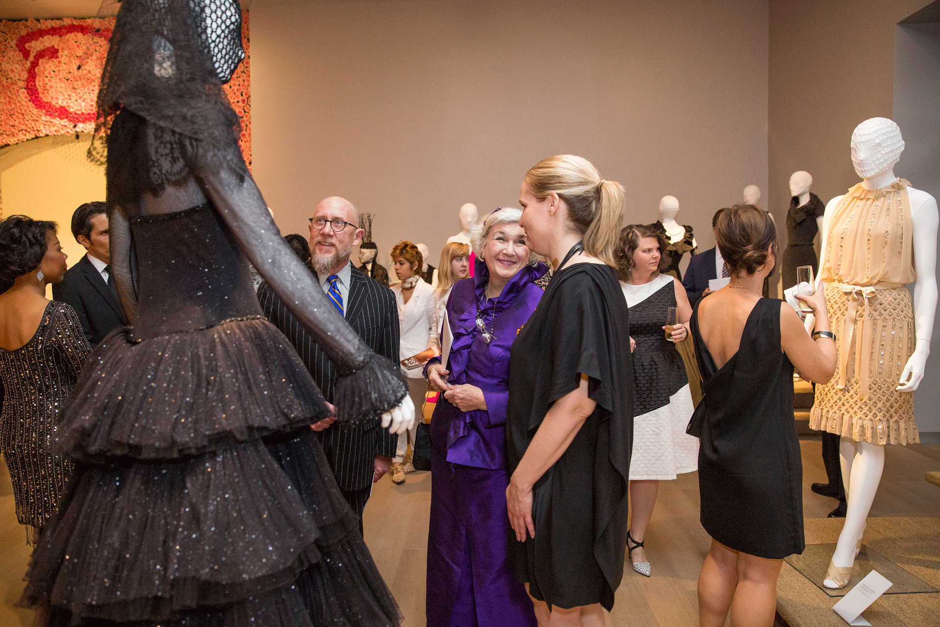 Visitors gaze at Oscar de la Renta dresses on display at SCAD Museum of Art