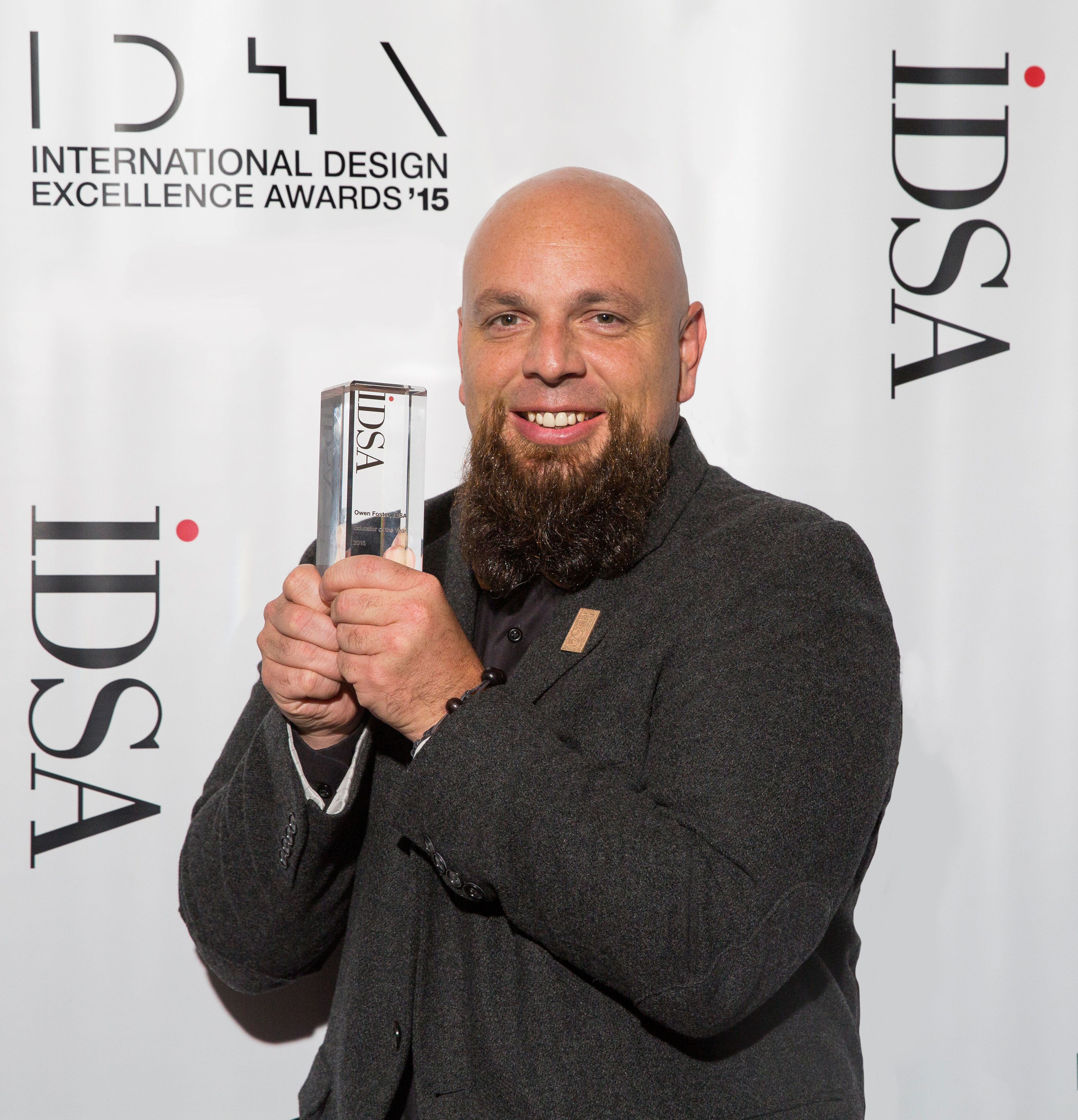 Industrial design professor Owen Foster holds the 2015 IDSA award