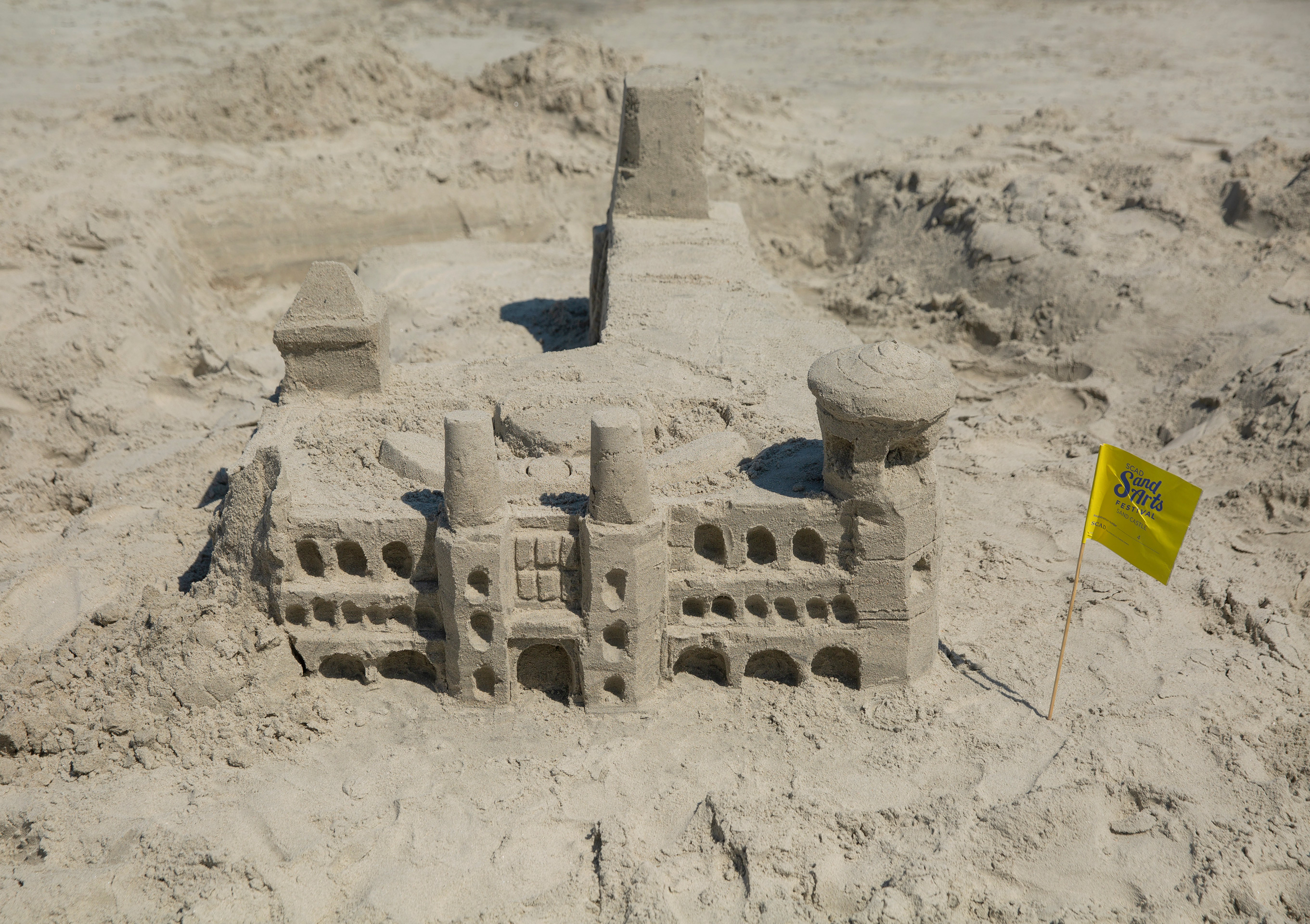Three story sand castle with decorative columns