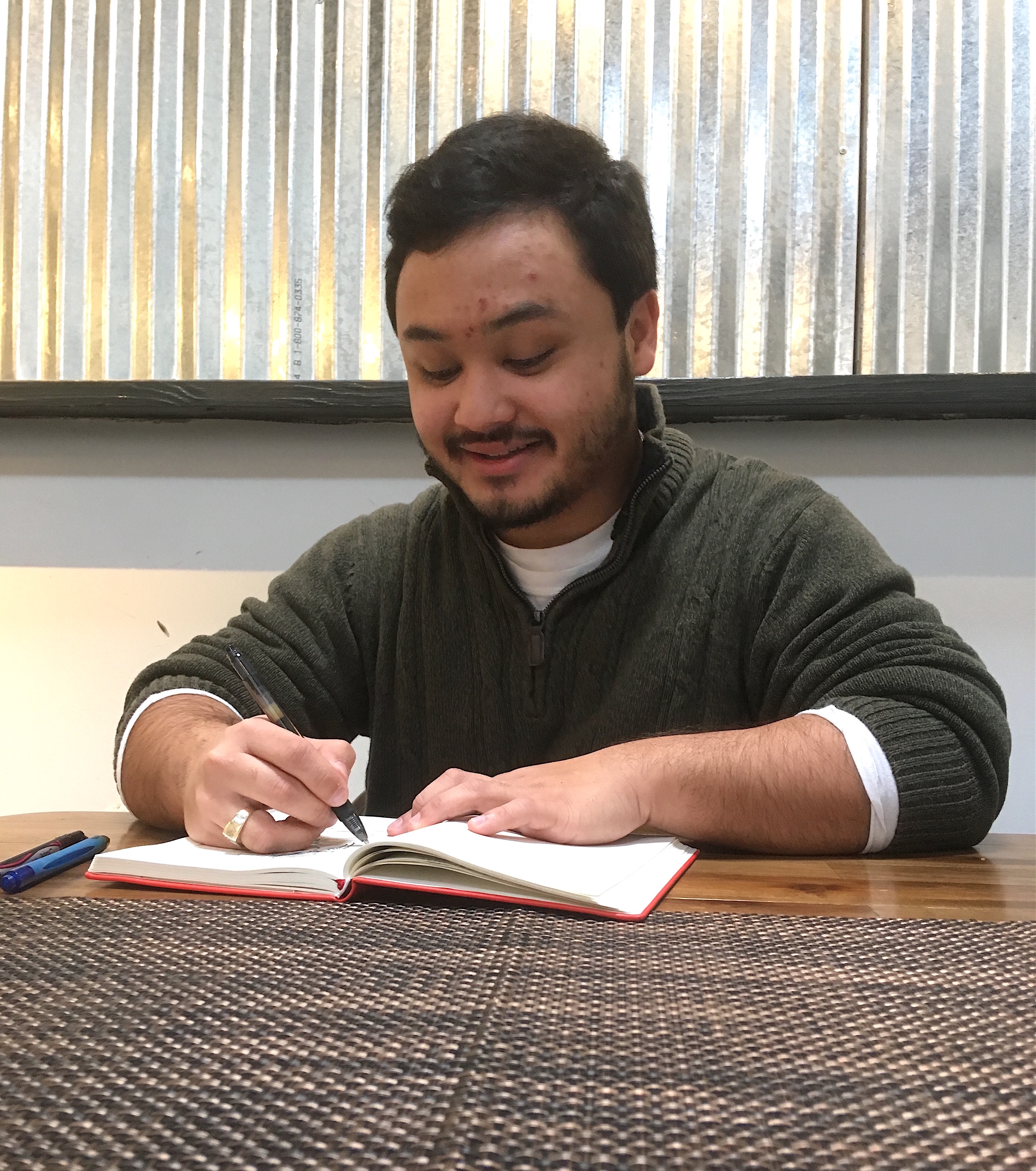 Kenneth Tryal signs book