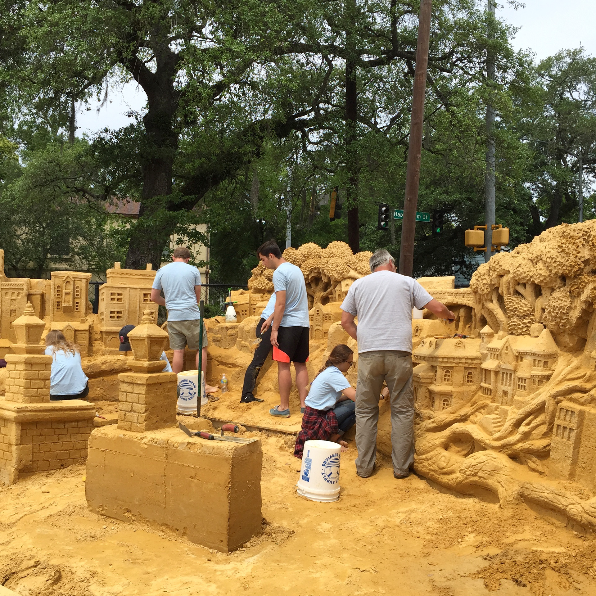 SCAD students assist Ted Siebert in a large sand sculpture