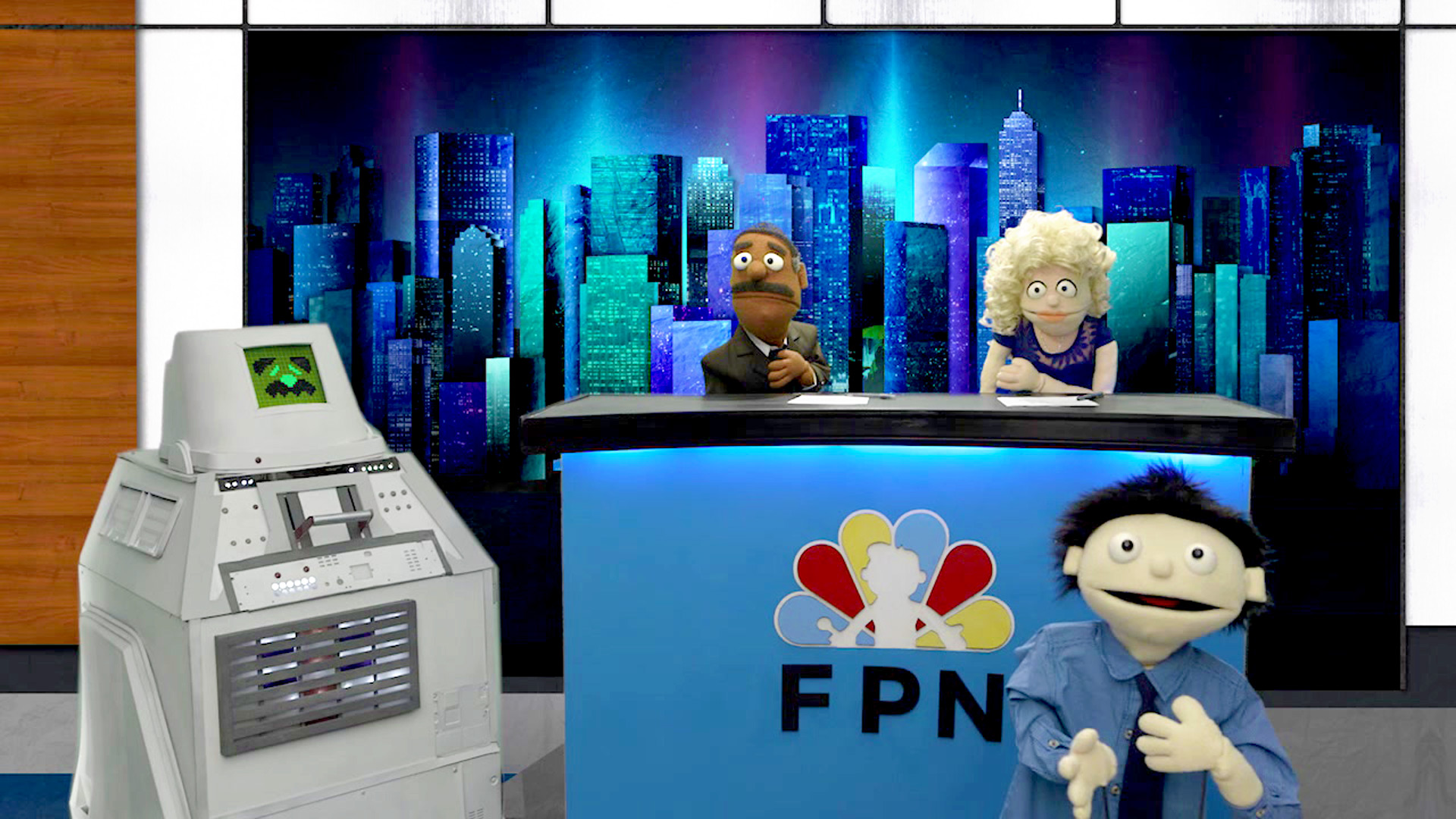 Three puppets on a news set