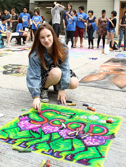 Alissa Berkhan works on her sidewalk art.
