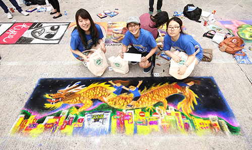 Laura Kwon, Peggy Ip and Yi Jeong Koh work on their sidewalk art