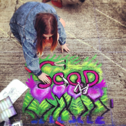 Alissa Berkhan works on her sidewalk artwork
