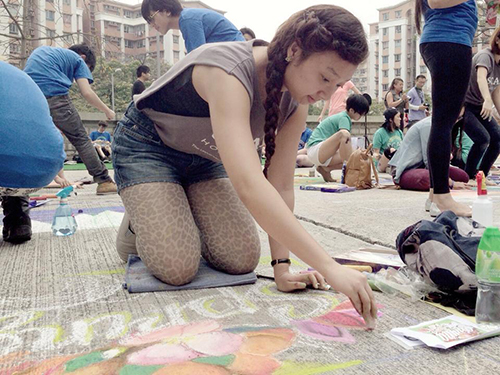 Student working on sidewalk art