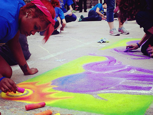 Student working on her sidewalk artwork