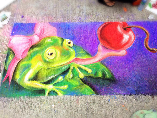 Sidewalk art featuring a frog and a cherry