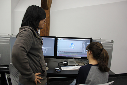 Two students work together on a computer