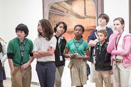 Students look at artwork