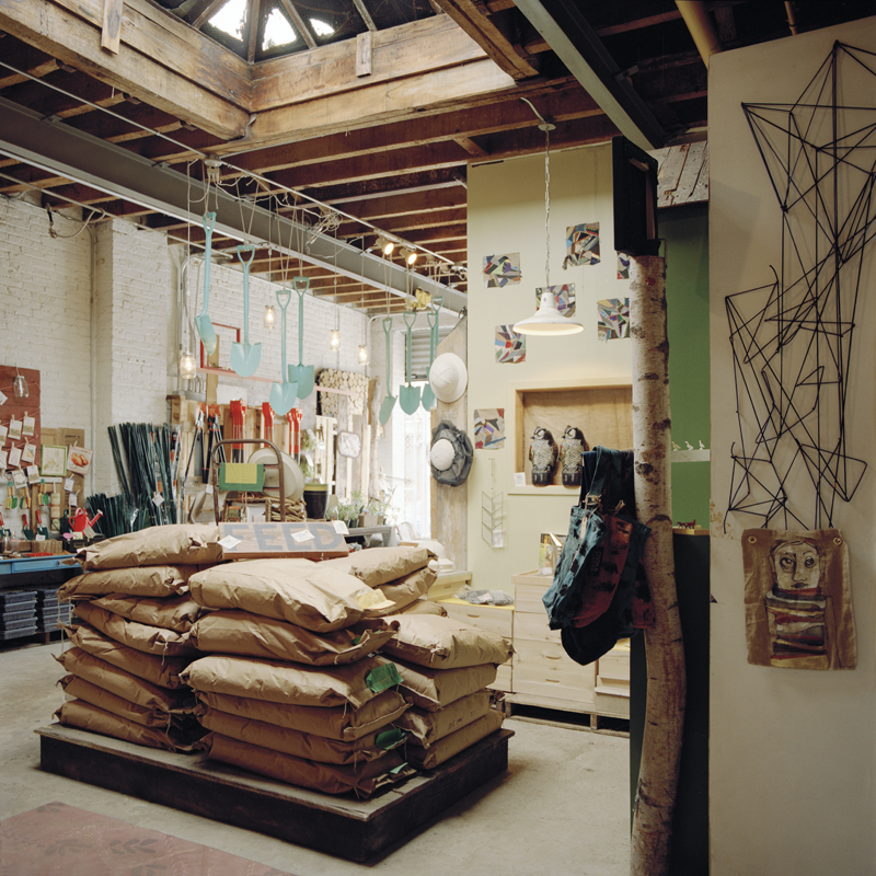 Domestic Construction studio with pastel blue shovels hanging from the ceiling