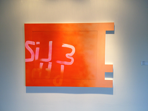 Red artwork hung on gallery wall
