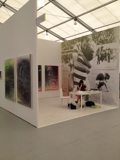 Woman sits at desk inside gallery